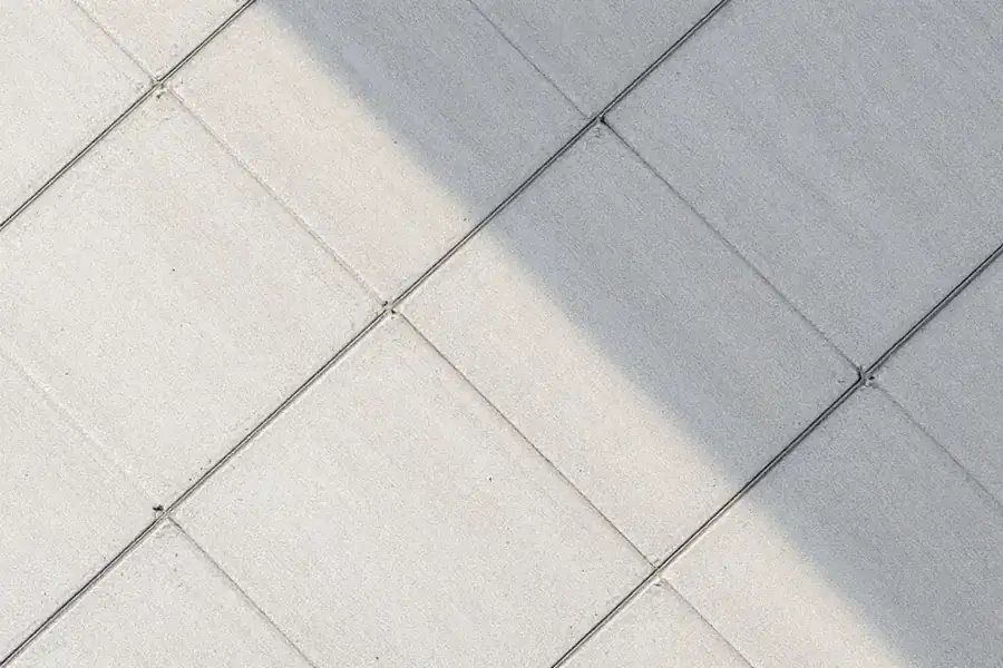 Pale broom-finished concrete sample with fine parallel lines