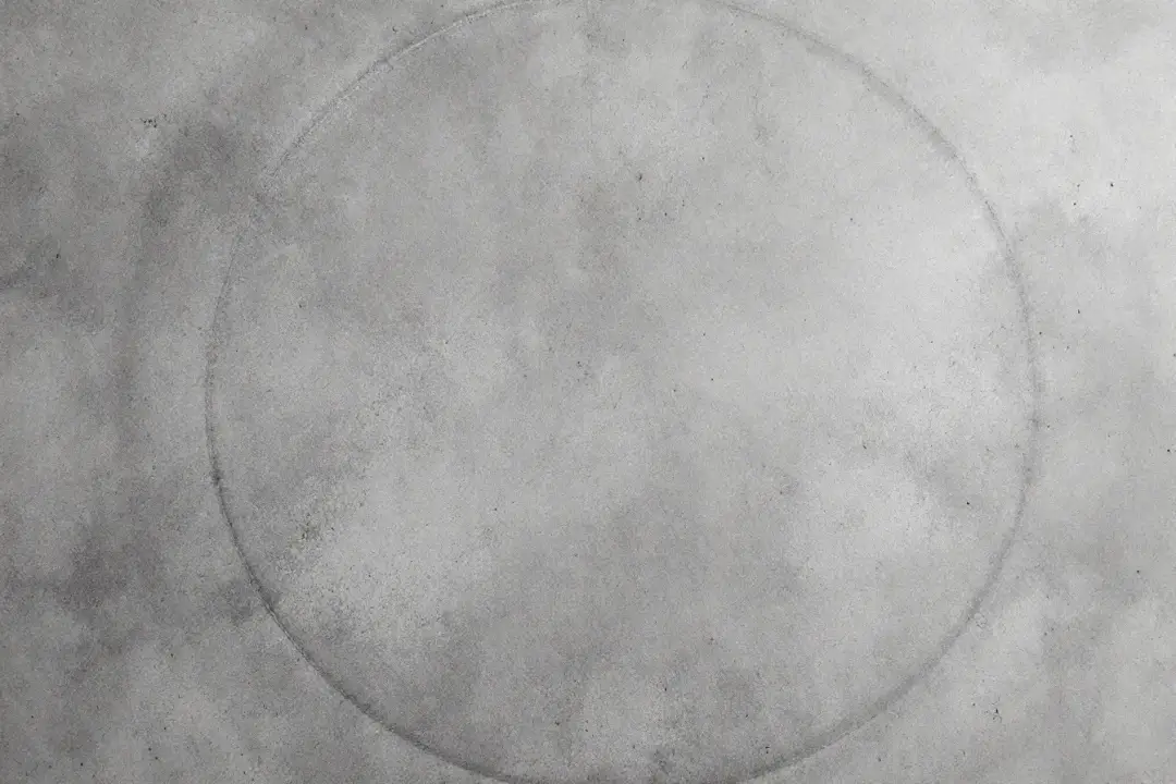 Burnished concrete sample with soft matte sheen and trowel arcs