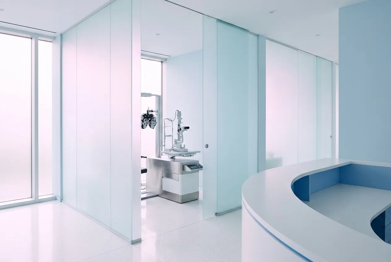 Frosted-glass consultation suites and diagnostic equipment inside the clinic